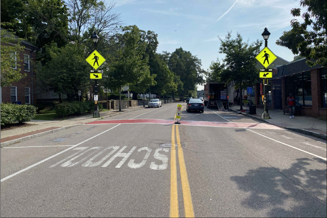 View of street with cars and signs
