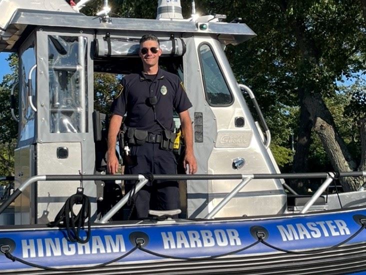 Harbormaster standing in boat on land